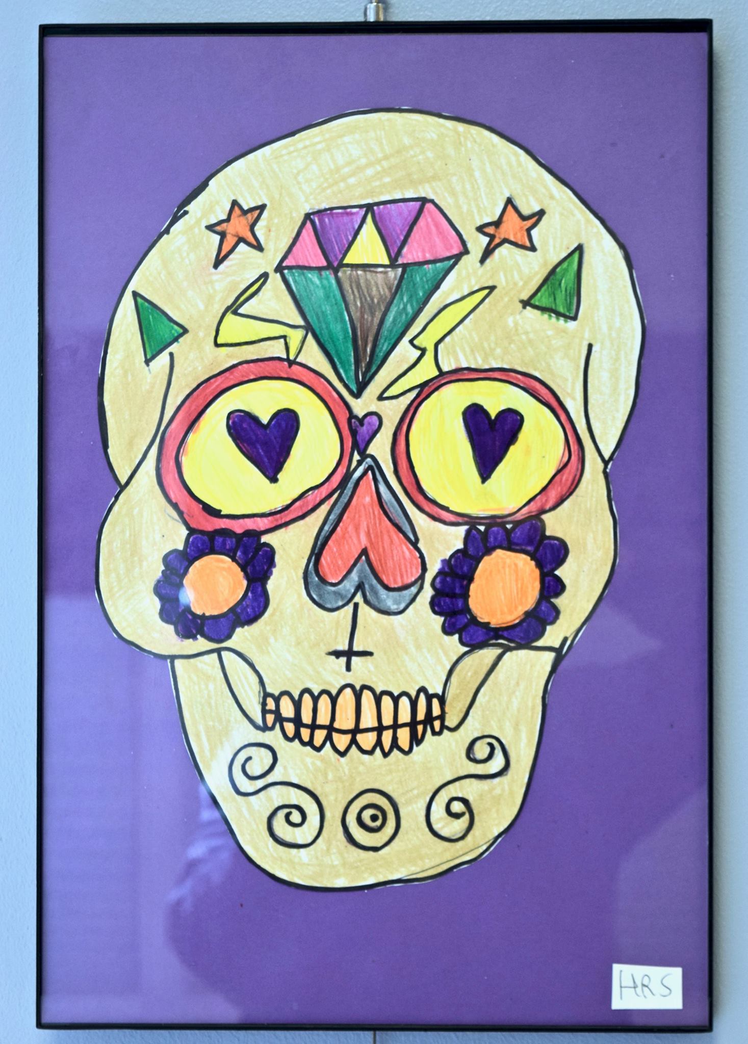 painting of a decorated Day of the Dead skull
