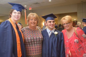Two graduates with their moms