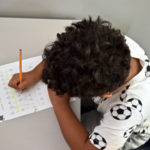 Young boy practicing handwriting
