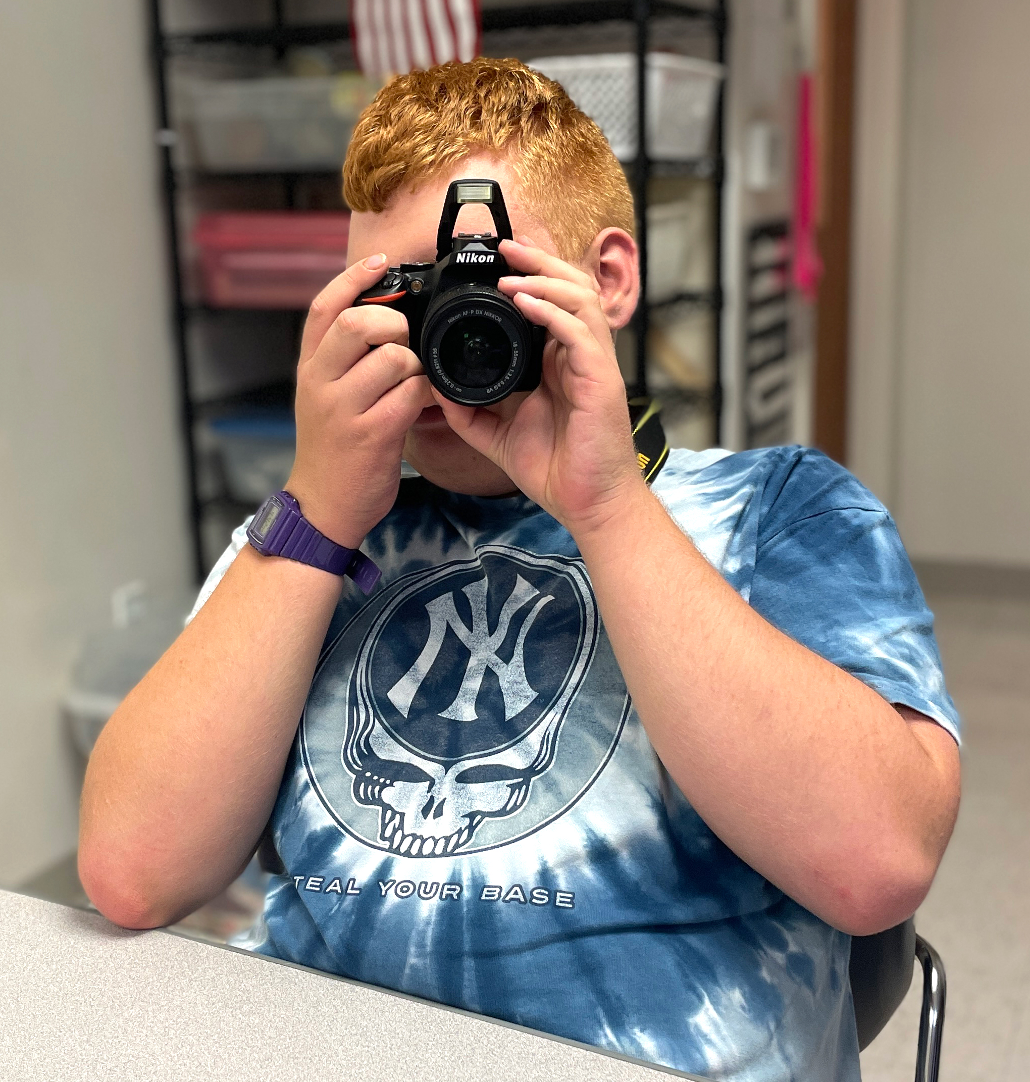 Student in Academy360's digital photography club using a camera.